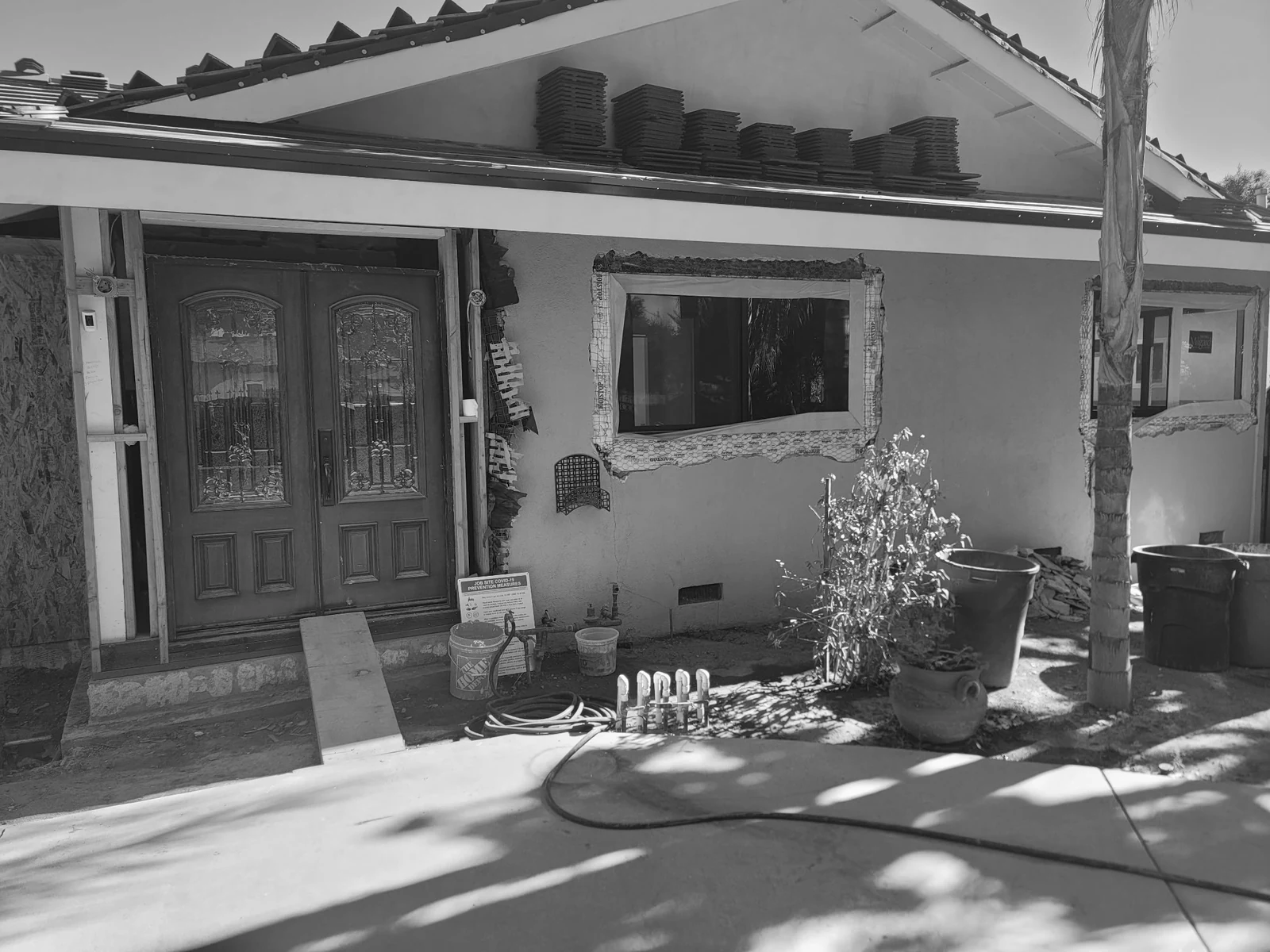 Front of the home with the roof and exterior being rebuilt